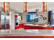 Red and white modern kitchen features stainless steel appliances and stunning city views at 200 W Sahara Ave # 4101, Las Vegas, NV 89102