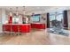 Sleek kitchen featuring red cabinets, stainless steel appliances, and an adjacent dining area with city views at 200 W Sahara Ave # 4101, Las Vegas, NV 89102