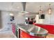 Contemporary kitchen featuring red cabinetry, stainless steel countertop, and open layout with city views at 200 W Sahara Ave # 4101, Las Vegas, NV 89102