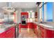 Modern kitchen featuring red cabinetry, stainless steel appliances, and a spacious countertop at 200 W Sahara Ave # 4101, Las Vegas, NV 89102