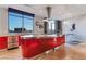 Modern kitchen with red cabinetry, stainless steel appliances, and a large window with city views at 200 W Sahara Ave # 4101, Las Vegas, NV 89102