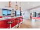 Stylish kitchen with red cabinets, bar seating, stainless steel appliances, and a large window showcasing city views at 200 W Sahara Ave # 4101, Las Vegas, NV 89102