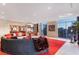 Large open living space with red rug, wrap around couch, floor to ceiling windows, and city views at 200 W Sahara Ave # 4101, Las Vegas, NV 89102