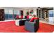 Modern living room features a red rug, sectional couch, and fantastic city views at 200 W Sahara Ave # 4101, Las Vegas, NV 89102