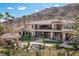 Expansive backyard featuring a patio, pool, desert landscaping, and mountain views at 2540 Red Arrow Dr, Las Vegas, NV 89135