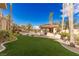 Lush backyard oasis with a custom pool, a cabana, and tropical landscaping at 2540 Red Arrow Dr, Las Vegas, NV 89135