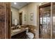 Bathroom with a stone shower, natural light, and a vanity with granite counters at 2540 Red Arrow Dr, Las Vegas, NV 89135