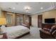 Comfortable bedroom with a large decorative ceiling, natural lighting, and a dark wood door at 2540 Red Arrow Dr, Las Vegas, NV 89135