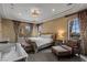 Serene bedroom featuring ample lighting, stylish furniture, and a balcony view at 2540 Red Arrow Dr, Las Vegas, NV 89135