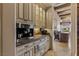 Built-in coffee bar featuring stainless steel appliances, custom cabinetry, and granite countertops at 2540 Red Arrow Dr, Las Vegas, NV 89135