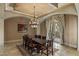 Formal dining room with a large wooden table, elegant chandelier, and access to the patio at 2540 Red Arrow Dr, Las Vegas, NV 89135