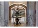 Grand foyer with a decorative table, marble floors, and an open view to the living area at 2540 Red Arrow Dr, Las Vegas, NV 89135