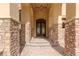 Elegant home entrance with a stone pathway and ornate double doors at 2540 Red Arrow Dr, Las Vegas, NV 89135
