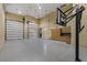 Spacious garage with two-car access, high ceilings, a basketball hoop, and cabinet storage at 2540 Red Arrow Dr, Las Vegas, NV 89135