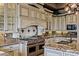 Close up of the gourmet kitchen featuring a professional-grade range and custom tile backsplash at 2540 Red Arrow Dr, Las Vegas, NV 89135