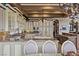 View of gourmet kitchen and formal dining area, featuring granite countertops, island, and custom cabinetry at 2540 Red Arrow Dr, Las Vegas, NV 89135