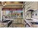 A well-appointed kitchen with an island, stainless steel appliances, and views of the outdoor space at 2540 Red Arrow Dr, Las Vegas, NV 89135