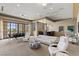 This living room offers seating, a poker table, a bar, and large windows at 2540 Red Arrow Dr, Las Vegas, NV 89135