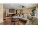 Open layout features a comfortable seating area with a ceiling fan and wood floors at 2540 Red Arrow Dr, Las Vegas, NV 89135