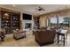 Cozy living room with custom built-ins, fireplace, and large windows offering bright natural light and outdoor views at 2540 Red Arrow Dr, Las Vegas, NV 89135