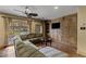 Comfortable living room features a ceiling fan, hardwood floors, and beautiful built-in cabinets at 2540 Red Arrow Dr, Las Vegas, NV 89135