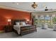 Comfortable main bedroom featuring a king-sized bed, sitting area, and natural light from large windows at 2540 Red Arrow Dr, Las Vegas, NV 89135