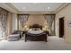 Relaxing bedroom with decorative curtains, chaise lounge, and king bed at 2540 Red Arrow Dr, Las Vegas, NV 89135