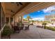 An outdoor living area with a covered patio, a fire pit, and comfortable seating at 2540 Red Arrow Dr, Las Vegas, NV 89135