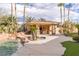 Resort-style pool area featuring a covered outdoor kitchen and bar with beautiful desert landscaping at 2540 Red Arrow Dr, Las Vegas, NV 89135
