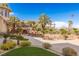 Backyard pool and tropical landscaping, set against a backdrop of palm trees at 2540 Red Arrow Dr, Las Vegas, NV 89135