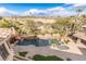 A luxurious pool with a grotto, spa, and a well manicured desert landscape provides a backyard oasis at 2540 Red Arrow Dr, Las Vegas, NV 89135