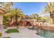 A tropical pool oasis with rock features, a waterslide, and lush landscaping at 2540 Red Arrow Dr, Las Vegas, NV 89135