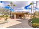 A poolside cabana with an outdoor kitchen, a dining area, and palm trees at 2540 Red Arrow Dr, Las Vegas, NV 89135