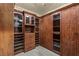 Custom walk-in closet with wooden cabinetry and shelving at 2540 Red Arrow Dr, Las Vegas, NV 89135