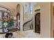 Elegant entryway with a wine cellar door and a view of the curved staircase at 2540 Red Arrow Dr, Las Vegas, NV 89135