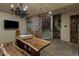 Cozy wine cellar featuring a wooden table, stone walls, and a staircase at 2540 Red Arrow Dr, Las Vegas, NV 89135