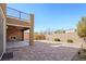 Spacious backyard with brick pavers, fireplace, balcony and desert landscaping at 2824 Shadows Edge Ct, Henderson, NV 89052