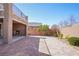 Paver backyard with a fireplace, landscaping, and a wall for privacy at 2824 Shadows Edge Ct, Henderson, NV 89052