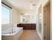 Bright bathroom featuring a soaking tub and rich wood cabinetry, creating a spa-like atmosphere at 2824 Shadows Edge Ct, Henderson, NV 89052