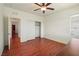 Bedroom featuring a ceiling fan, hardwood floors, closet, and natural light at 2824 Shadows Edge Ct, Henderson, NV 89052
