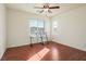 Bright bedroom with a ceiling fan, hardwood floors, and a large window at 2824 Shadows Edge Ct, Henderson, NV 89052