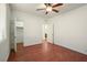 Bedroom with a ceiling fan, hardwood floors, closet, and bathroom access at 2824 Shadows Edge Ct, Henderson, NV 89052