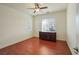 Well-lit bedroom with hardwood floors, ceiling fan, and a large window at 2824 Shadows Edge Ct, Henderson, NV 89052