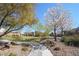 Picturesque community green space with flowering trees, walking paths, and well-maintained landscaping at 2824 Shadows Edge Ct, Henderson, NV 89052