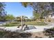 Relaxing community park with picnic tables, grassy areas, mature trees, and paved pathways, inviting residents to unwind at 2824 Shadows Edge Ct, Henderson, NV 89052