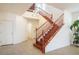 Bright and airy entryway with a wooden staircase, tile flooring, and ample natural light creating an inviting atmosphere at 2824 Shadows Edge Ct, Henderson, NV 89052