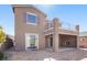 Back exterior view showcasing the fireplace, balcony, and brick-paved patio at 2824 Shadows Edge Ct, Henderson, NV 89052