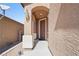 Inviting entryway featuring a classic-style door, elegant lighting fixture, and covered porch for a warm welcome at 2824 Shadows Edge Ct, Henderson, NV 89052