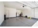 Spacious two-car garage featuring epoxy floors, storage space, and utility hookups at 2824 Shadows Edge Ct, Henderson, NV 89052