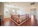 Upper landing area featuring chandelier, hardwood floors, and open staircase at 2824 Shadows Edge Ct, Henderson, NV 89052